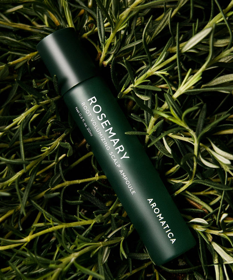 AROMATICA Rosemary Root Volumizing Scalp Ampoule 20ML bottle surrounded by rosemary leaves for hair care.