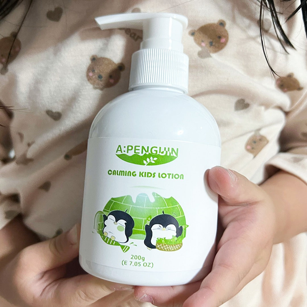 ATOMANDE Arctic Penguin Kids Children Calming Lotion Skin Soothing Moisturizing Body 200ml bottle held in child's hands