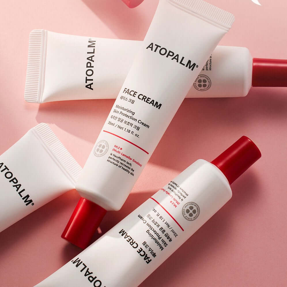 ATOPALM Face Cream 35ml in white tubes with red caps on a pink background