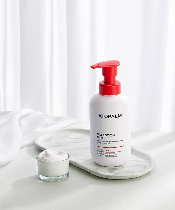 ATOPALM MLE Lotion 300ml bottle on a tray with a small jar of cream