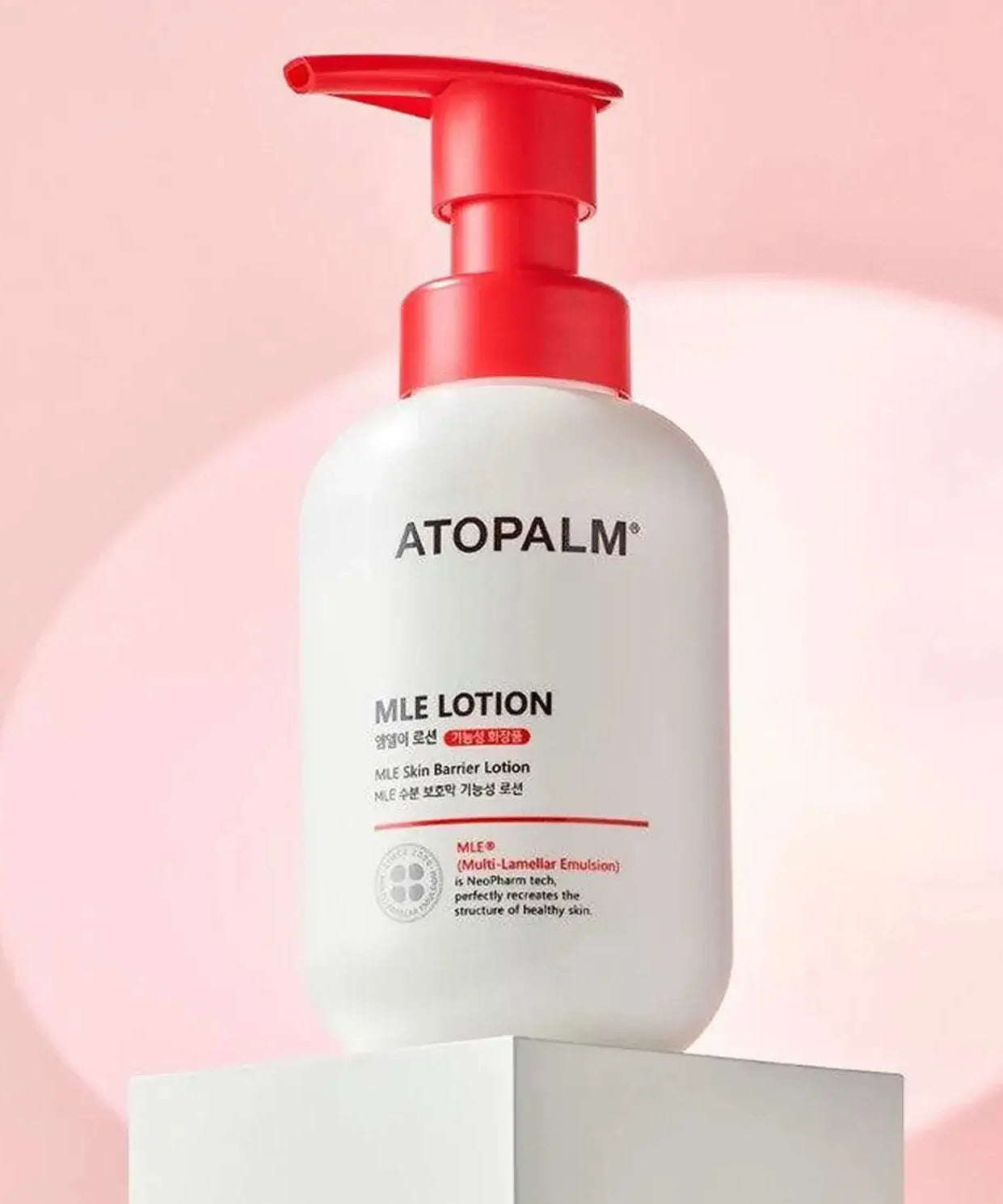 ATOPALM MLE Lotion 300ml on display with pink background.
