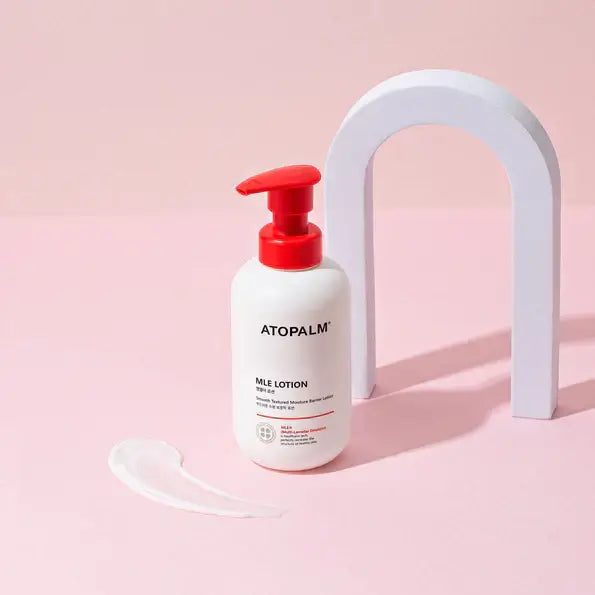 ATOPALM MLE Lotion 300ml bottle on pink background with lotion swatch