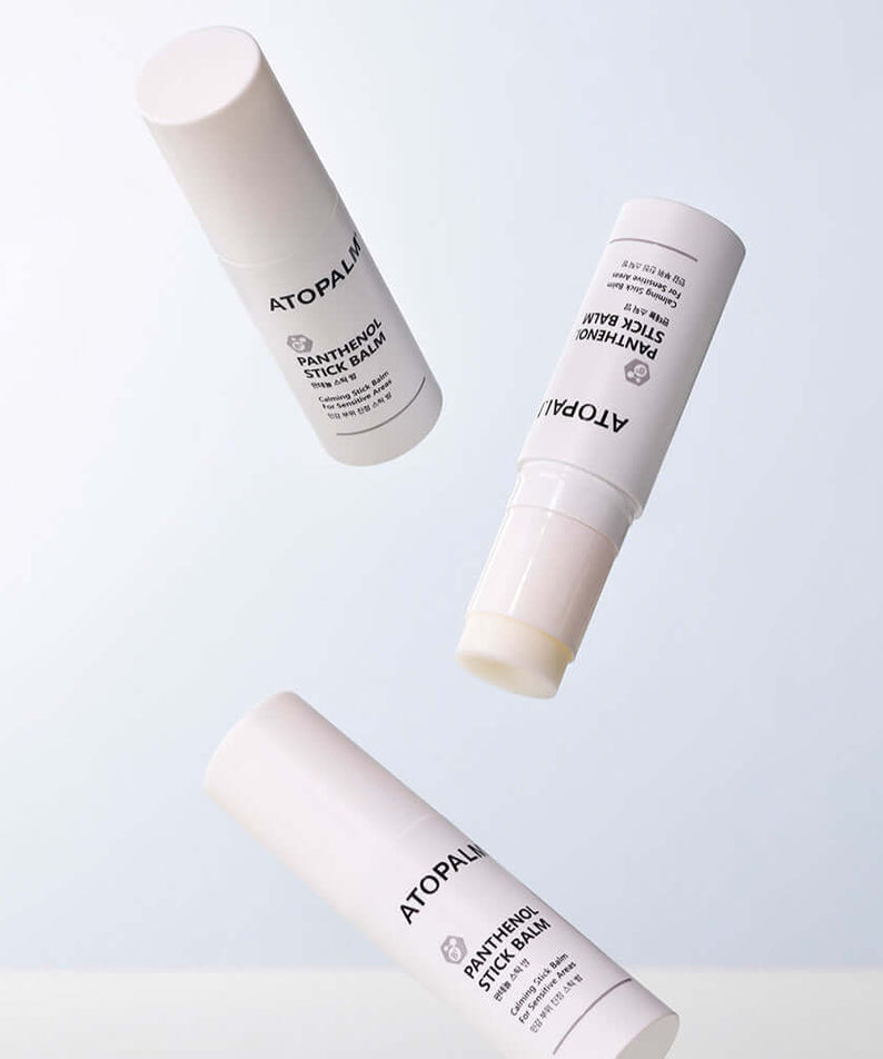 ATOPALM Panthenol Stick Balm 10g shown in three different angles on a light background