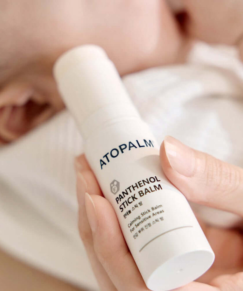 Close-up of ATOPALM Panthenol Stick Balm 10g in hand, highlighting the product design and packaging.