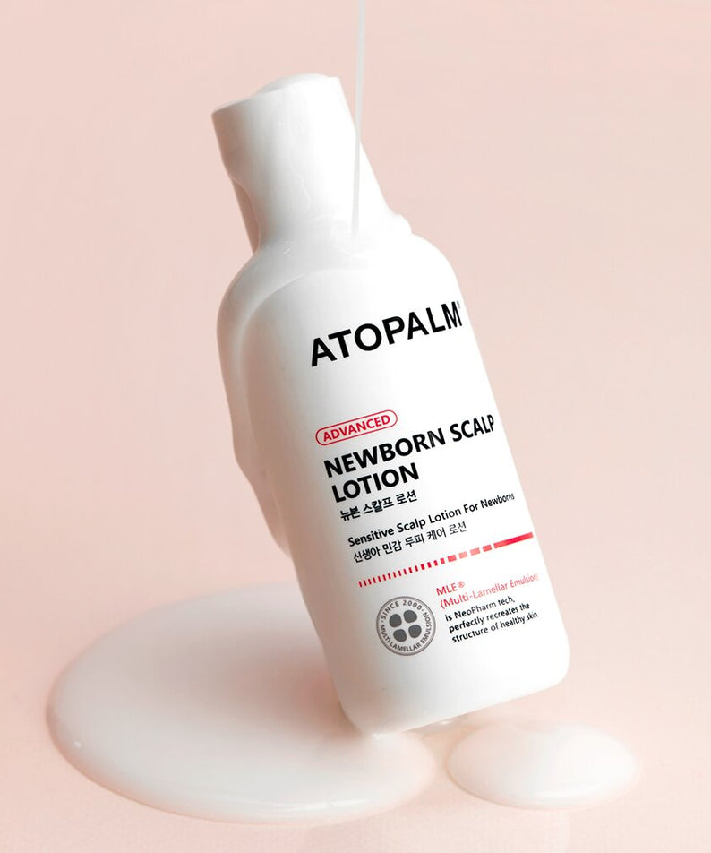 ATOPALM Newborn Scalp Lotion 100g bottle with lotion dripping on pink background