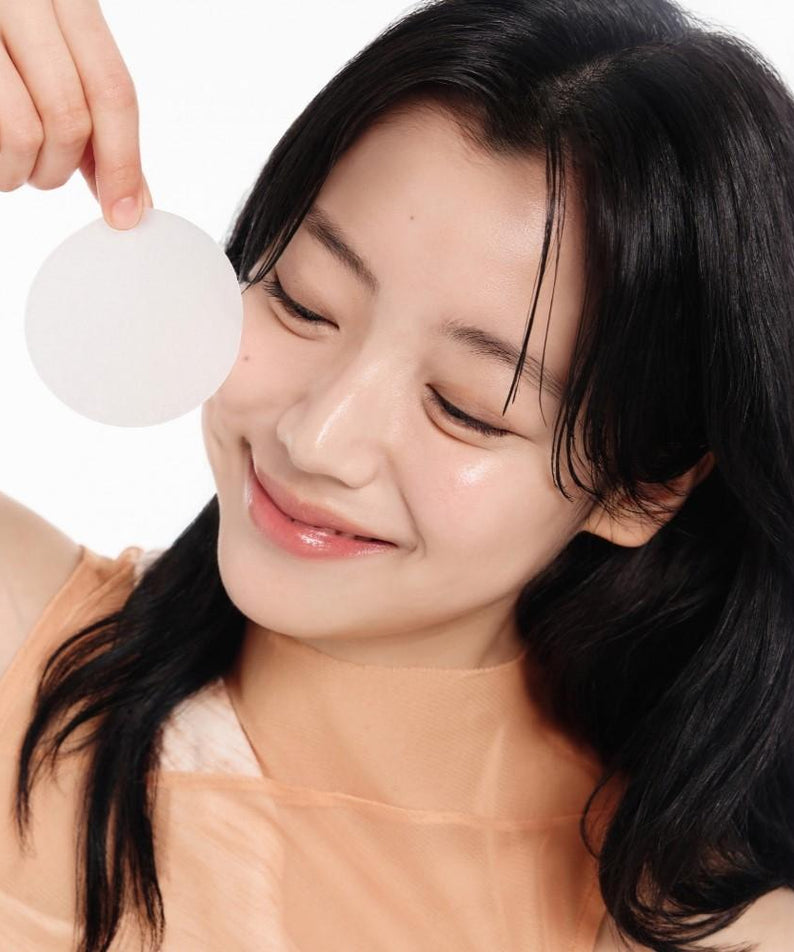 Woman applying ABIB Glutathiosome Dark Spot Pad Vita Touch 60 EA for skincare