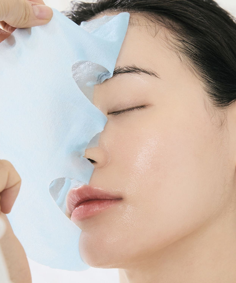Person applying DR.ALTHEA Aqua Blue Hydrating Mask (4ea) for hydration and skin rejuvenation; skincare routine.