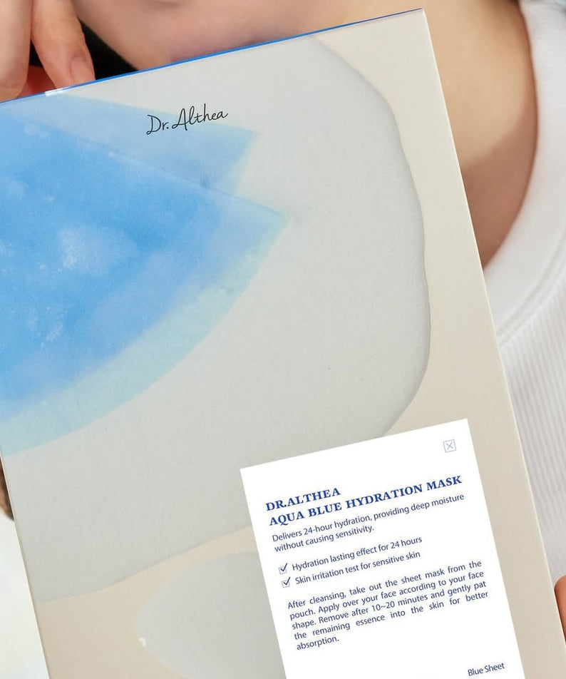 DR.ALTHEA Aqua Blue Hydrating Mask (4ea) package held by person, showcasing premium hydration skincare product.
