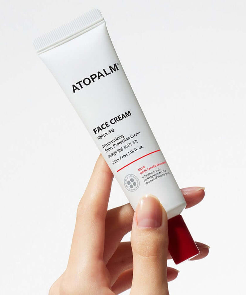 ATOPALM Face Cream 35ml tube held in hand, ideal for moisturizing and soothing skin.