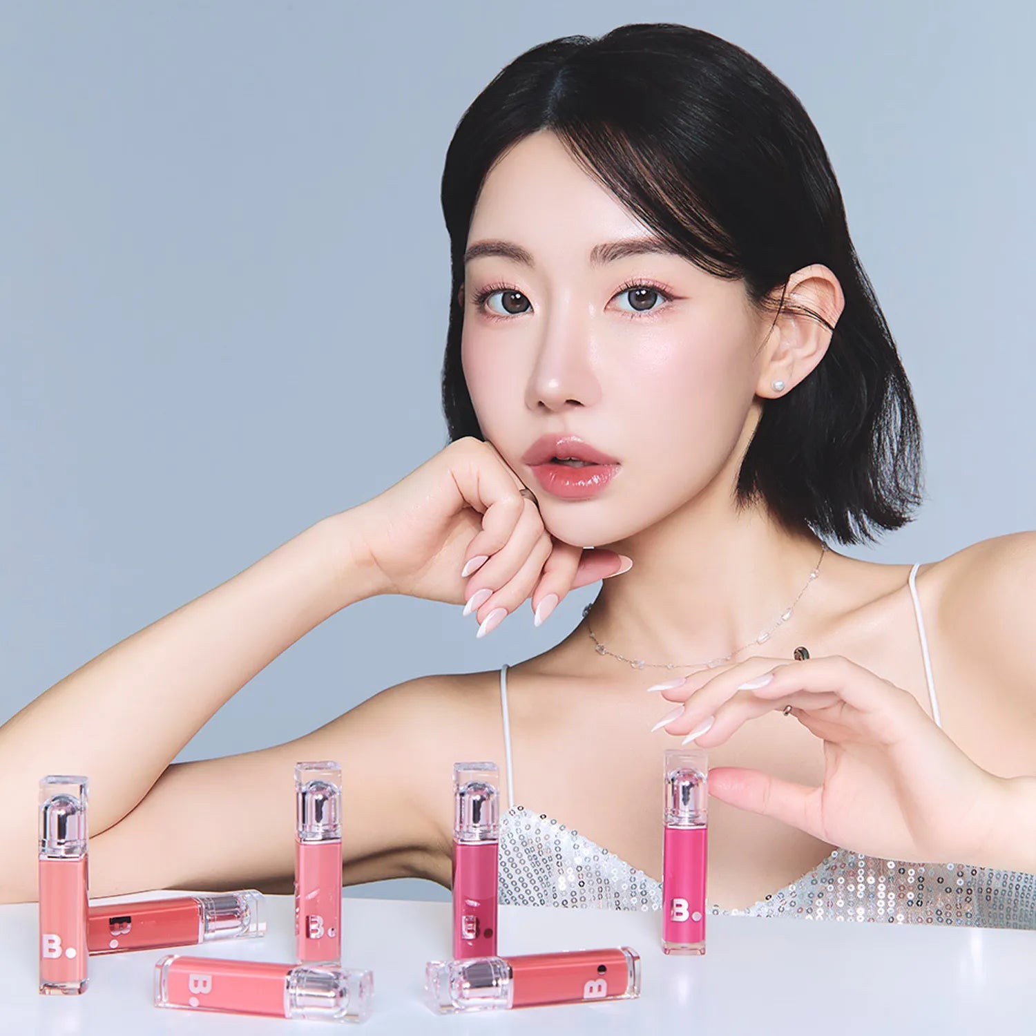 Model displaying BANILA CO Dew Glow Tint collection in various shades.