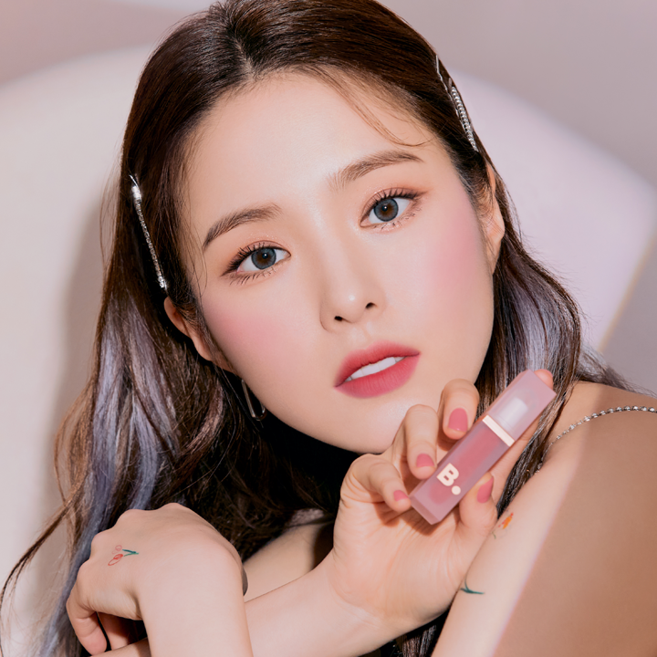 Model holding BANILA CO Water Drop Veil Tint showcasing makeup look