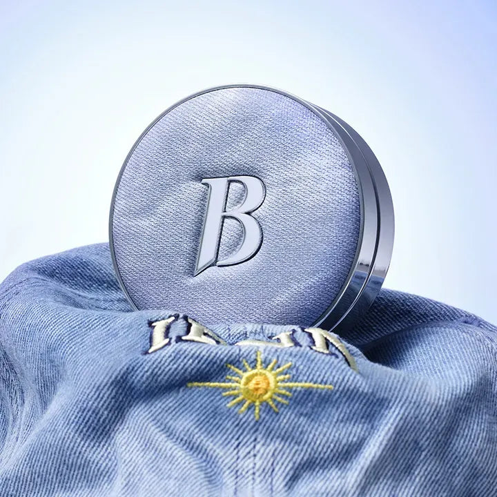 BANILACO Covericious Ultimate White Cushion on denim with embroidered sun design