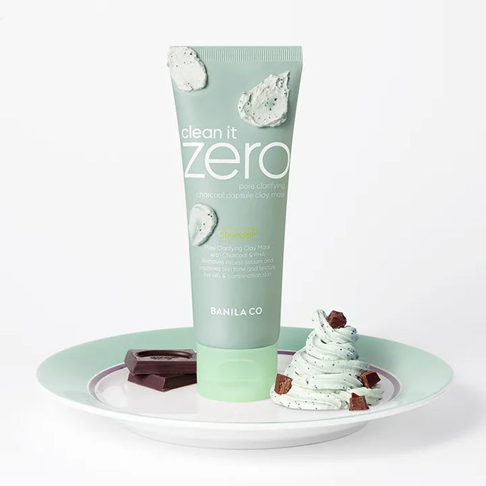 BANILA CO Clean It Zero Charcoal Capsule Pore Clay Mask 100g on decorative plate with chocolate and cream accents