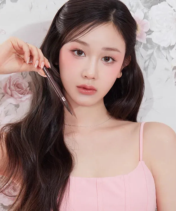 Woman holding BANILACO Powerproof Pen Eyeliner in floral background