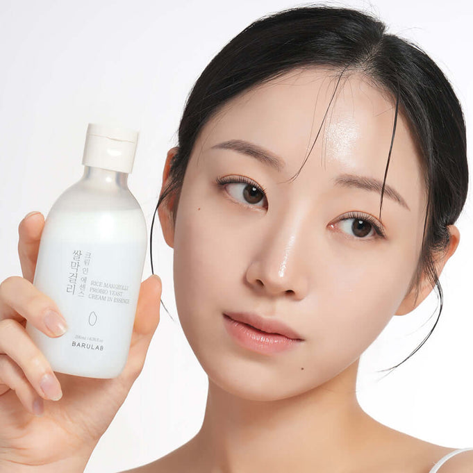 Person holding BARULAB Rice Makgeolli Probiotic Yeast Cream in Essence 200ml bottle
