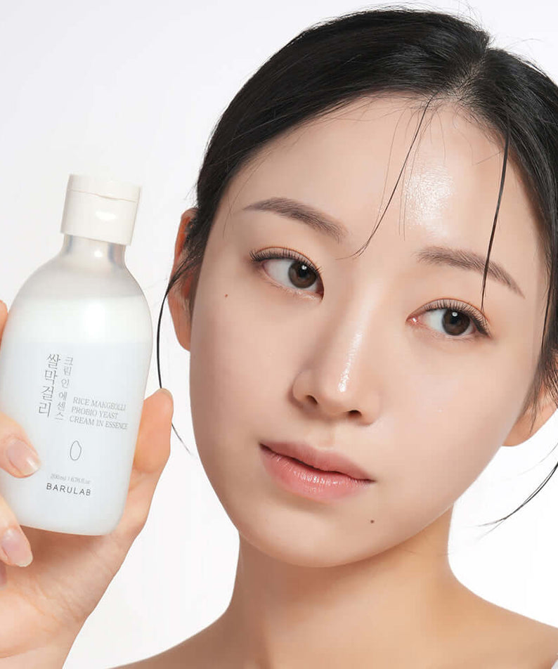 Person holding BARULAB Rice Makgeolli Probiotic Yeast Cream in Essence 200ml bottle