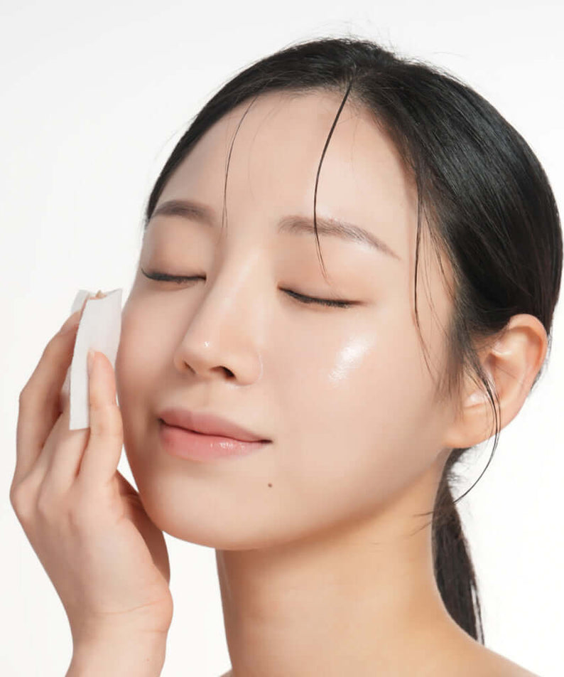 Woman applying BARULAB Rice Makgeolli Probiotic Yeast Cream in Essence 200ml to her face for skincare