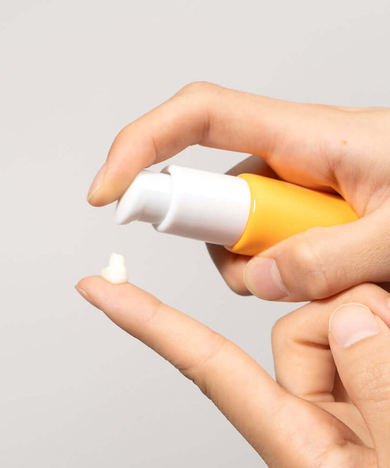 Applying BARULAB Vitamin C Niacinamide Whitening Eye Serum 30ml on fingertip