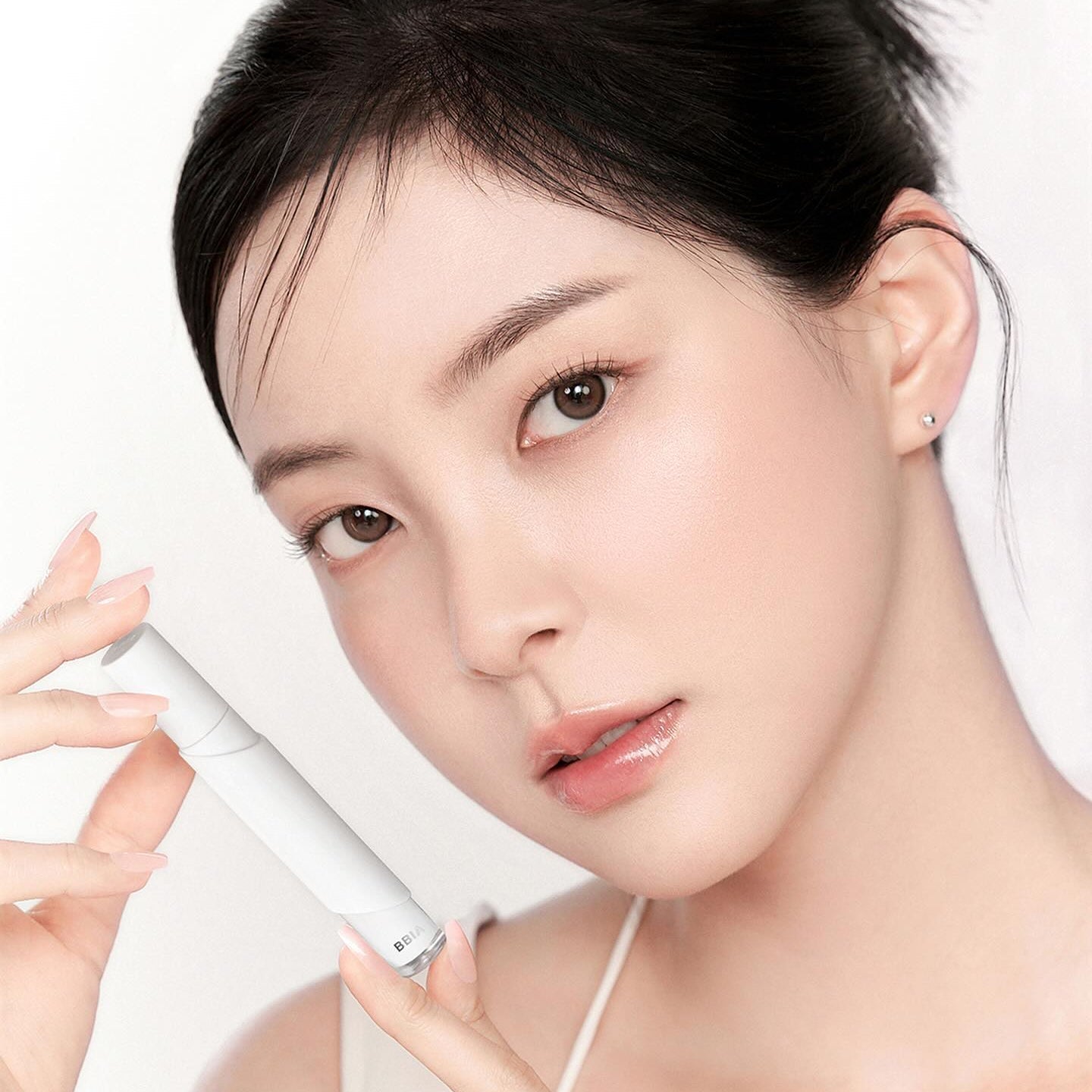 Model holding BBIA Eau Stay Concealer for flawless complexion
