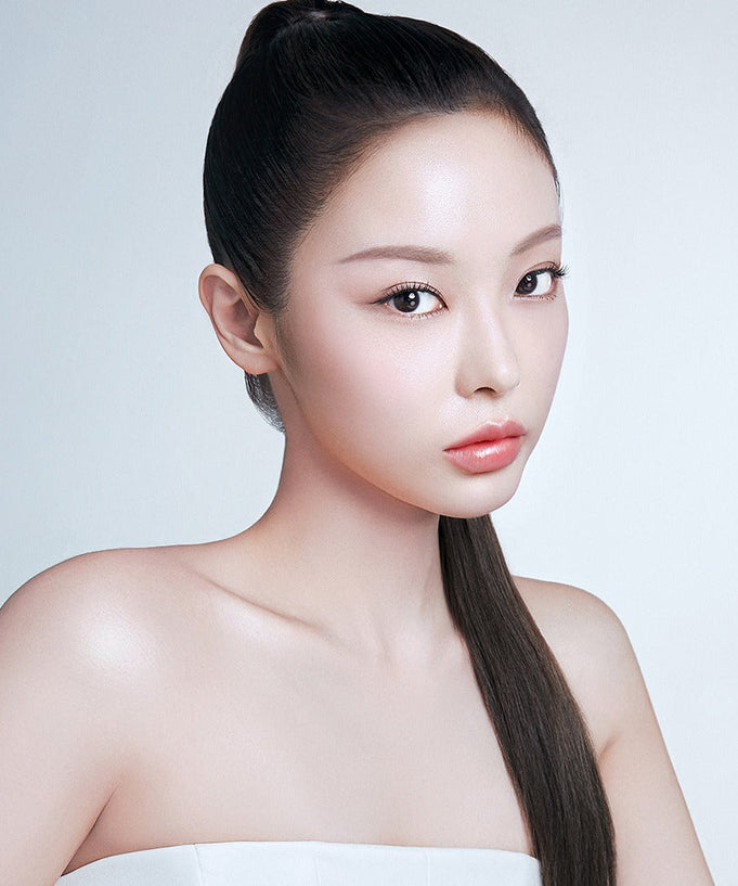 Model wearing BBIA Oh Powder Pact with flawless skin and sleek hairstyle
