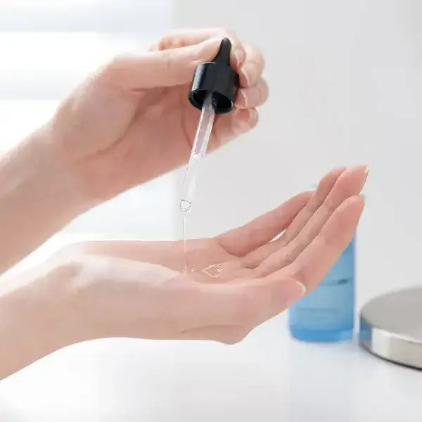 Applying BELIF Super Drops-Hyalucid 11% 30ml serum with dropper on hand