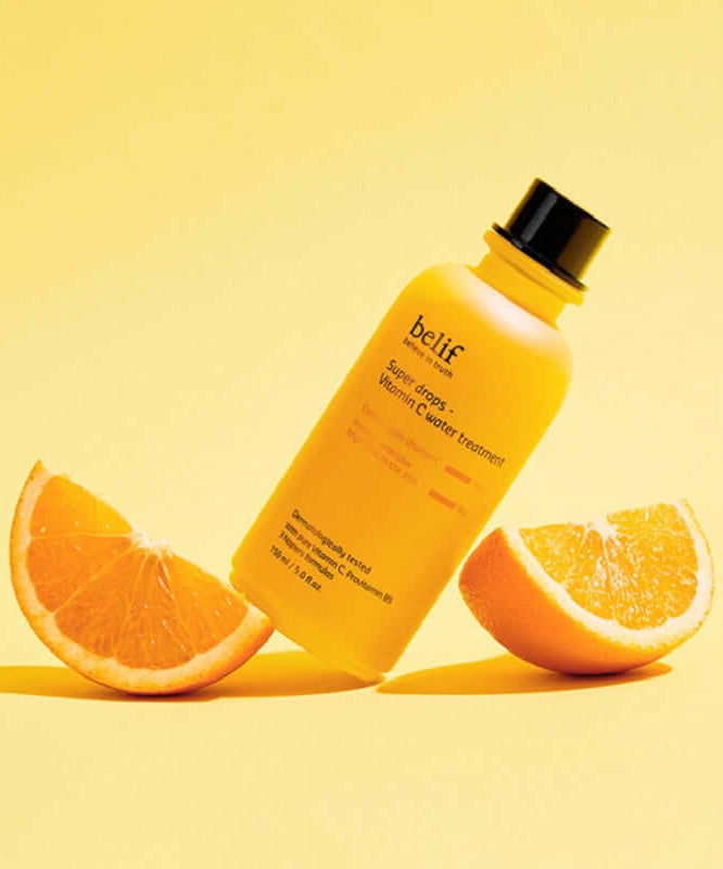 BELIF Super Drops-Vitamin C Water Treatment 150ml bottle with sliced oranges on a yellow background