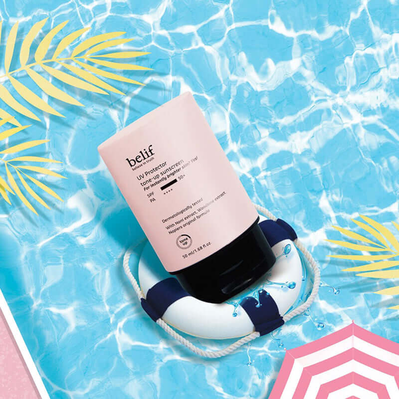 BELIF UV Protector Tone-up Sunscreen 50ml floating in pool with tropical design
