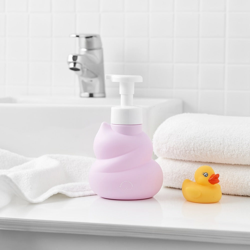 BELLBOY STUDIO Hippong Bubble Butt Cleanser in pink dispenser on bathroom counter with rubber duck and towels