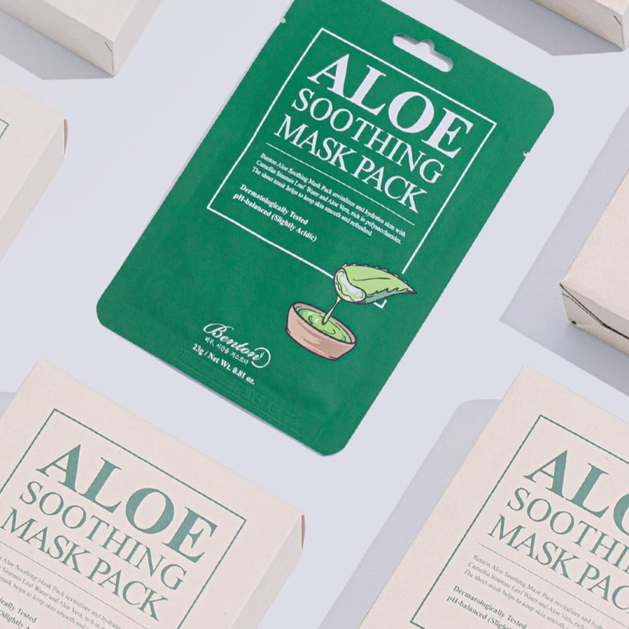 Flatlay of BENTON Aloe Soothing Mask Pack featuring green packaging with aloe leaf graphic, surrounded by multiple product boxes.