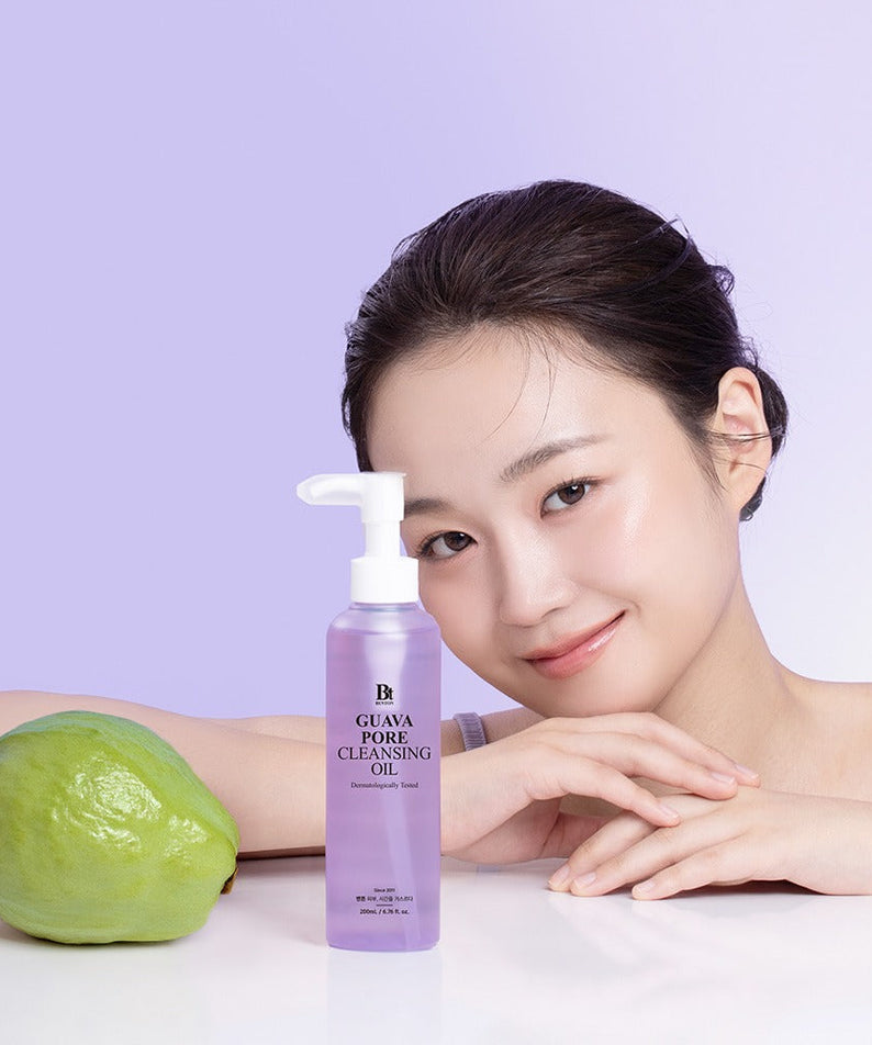 BENTON Guava Blackhead Pore Cleansing Oil 200ml next to smiling woman and guava fruit