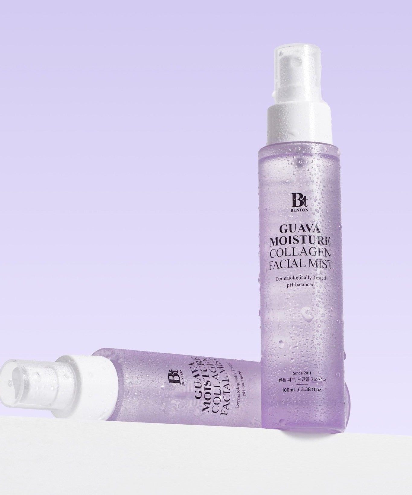 BENTON Guava Hydrating Collagen Mist 100ml skincare product with purple packaging, shown with mist droplets, for hydration and skincare benefits.