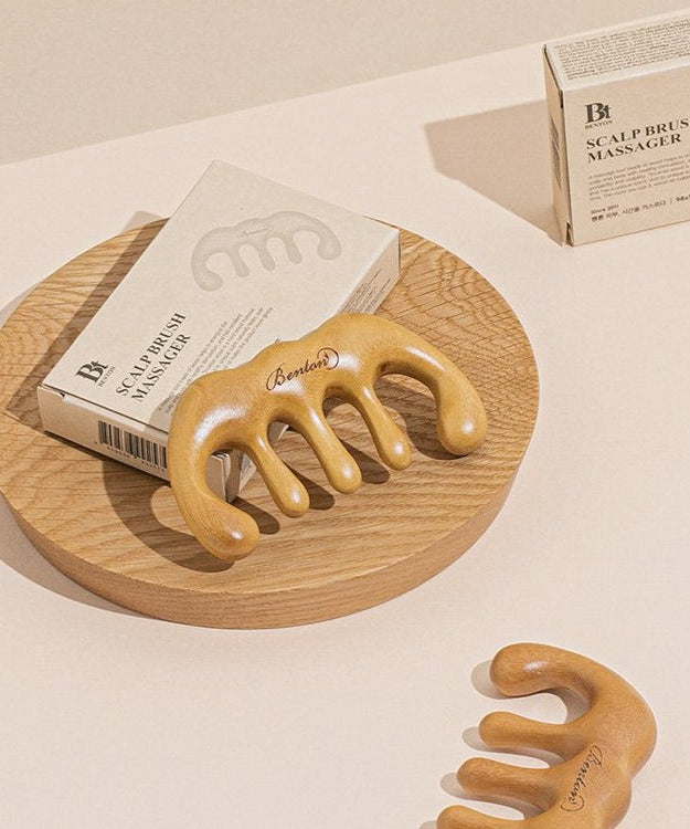 BENTON Scalp Brush Massager on wooden tray with packaging in a minimalist setting