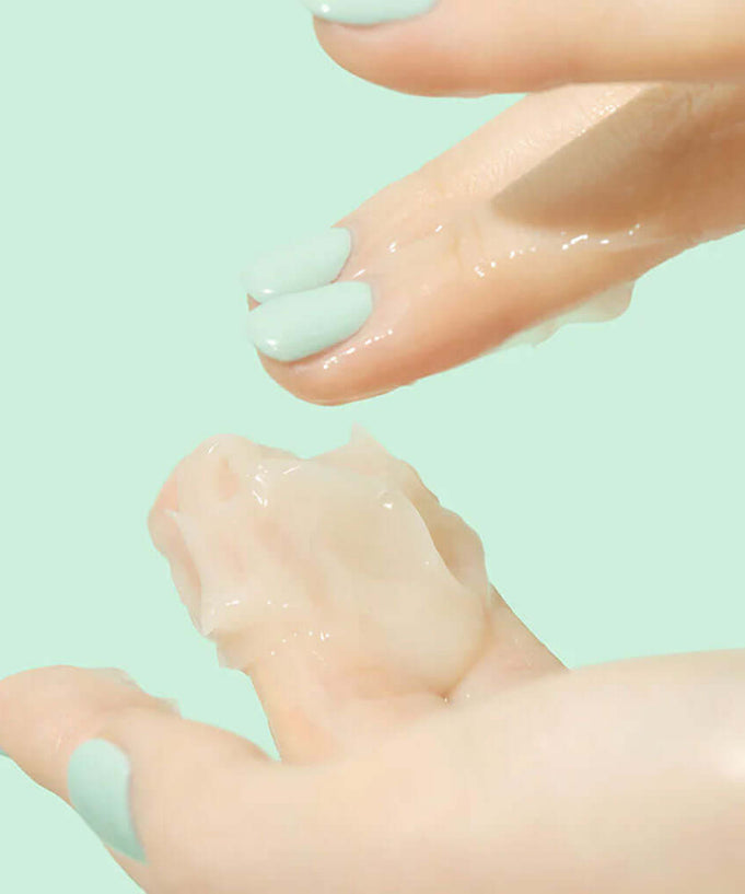 Application of BEPLAIN Cicaterol Cream on fingers against a green background.