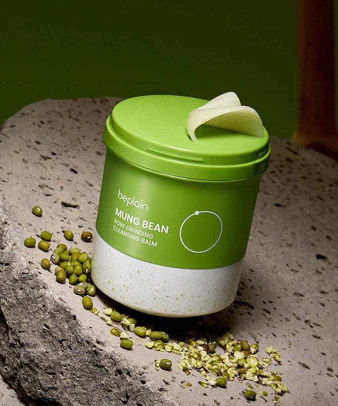 BEPLAIN Green Bean Pore Grinding Cleansing Balm on rocky surface with green beans