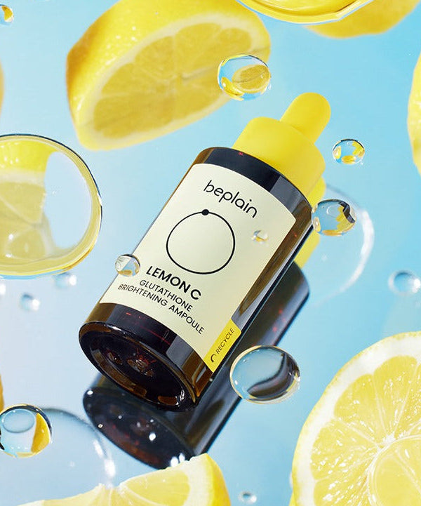 BEPLAIN Lemon Seed Glutathione Whitenning Ampoule 30ml surrounded by fresh lemon slices and water droplets
