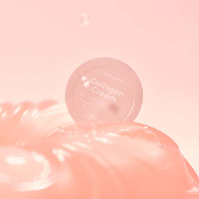 BLESSED MOON Collagen Kit cream container on a reflective surface with a soft pink background.