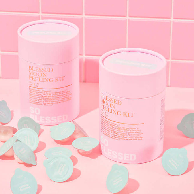 BLESSED MOON Pelling Kit with pink packaging and skincare products on a pink tiled background.
