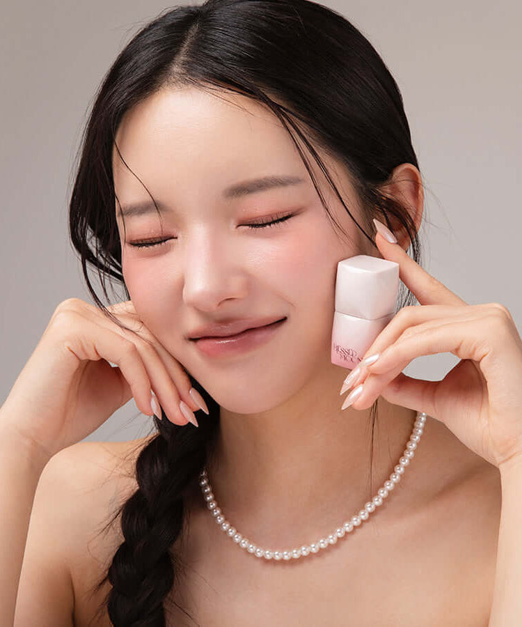 Woman smiling while holding BLESSED MOON Veil Melting Color Blush, showcasing its elegance and vibrant color payoff.