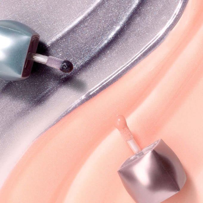 BLESSED MOON Veil Mood Lip Gloss open bottles with glossy texture background