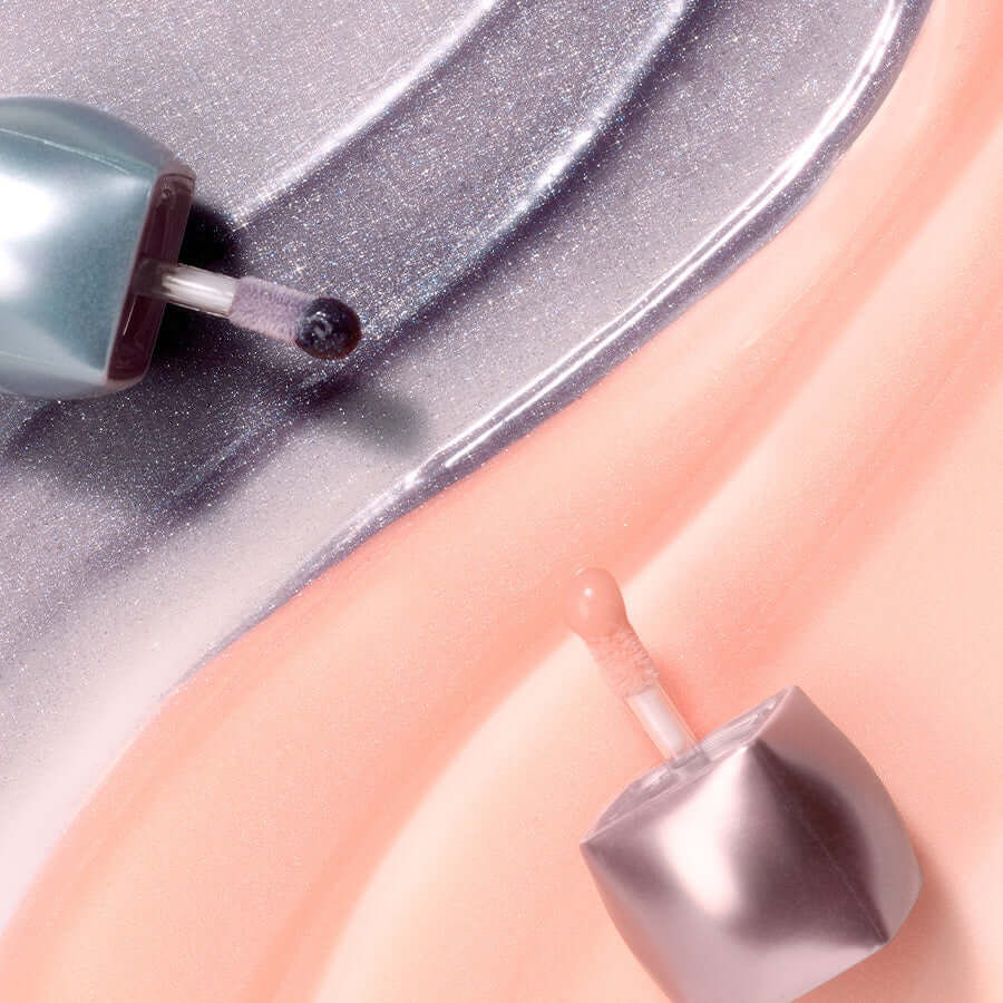 BLESSED MOON Veil Mood Lip Gloss open bottles with glossy texture background