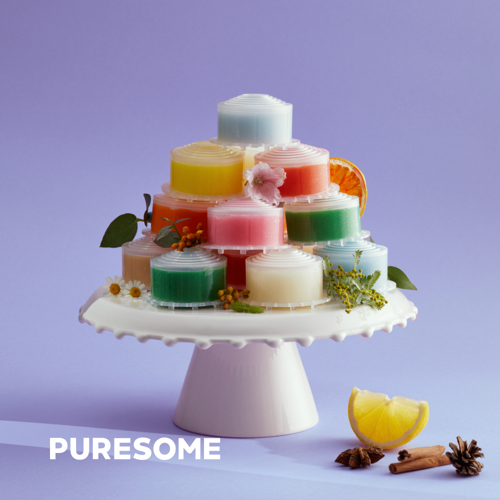 Colorful stacked shower filters on a cake stand by BODYLUV Vita Pure Filter, featuring flowers, citrus, and natural spices.