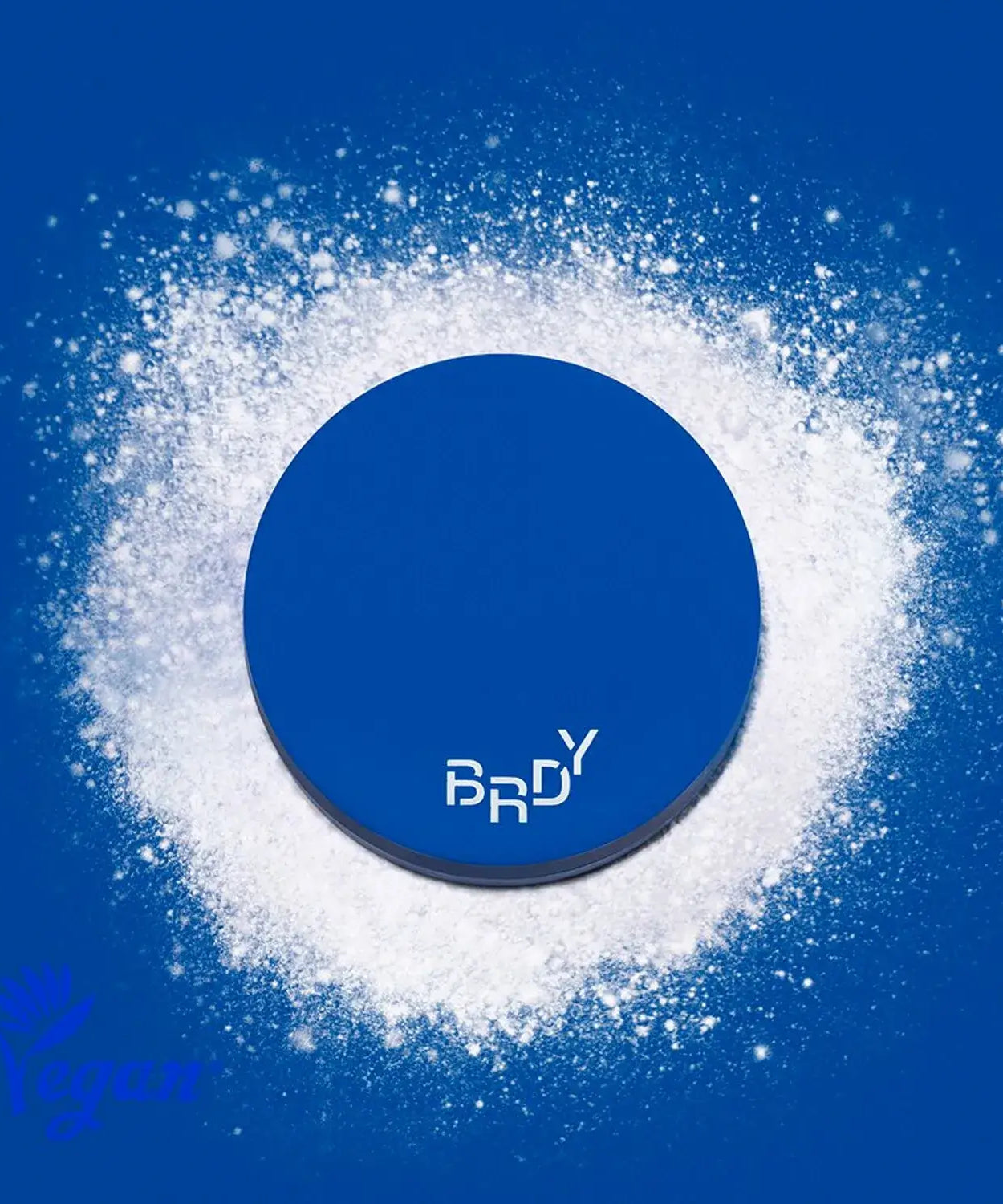 B.READY Blue Sebum Powder in a stylish blue container surrounded by white powder, highlighting its vegan and sebum control features.