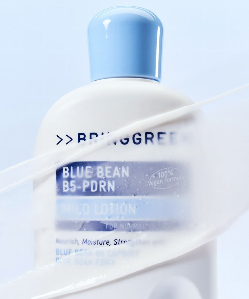 BRINGGREEN Blue Bean B5-PDRN Mild Lotion 230ml bottle with a light blue cap against a soft background.