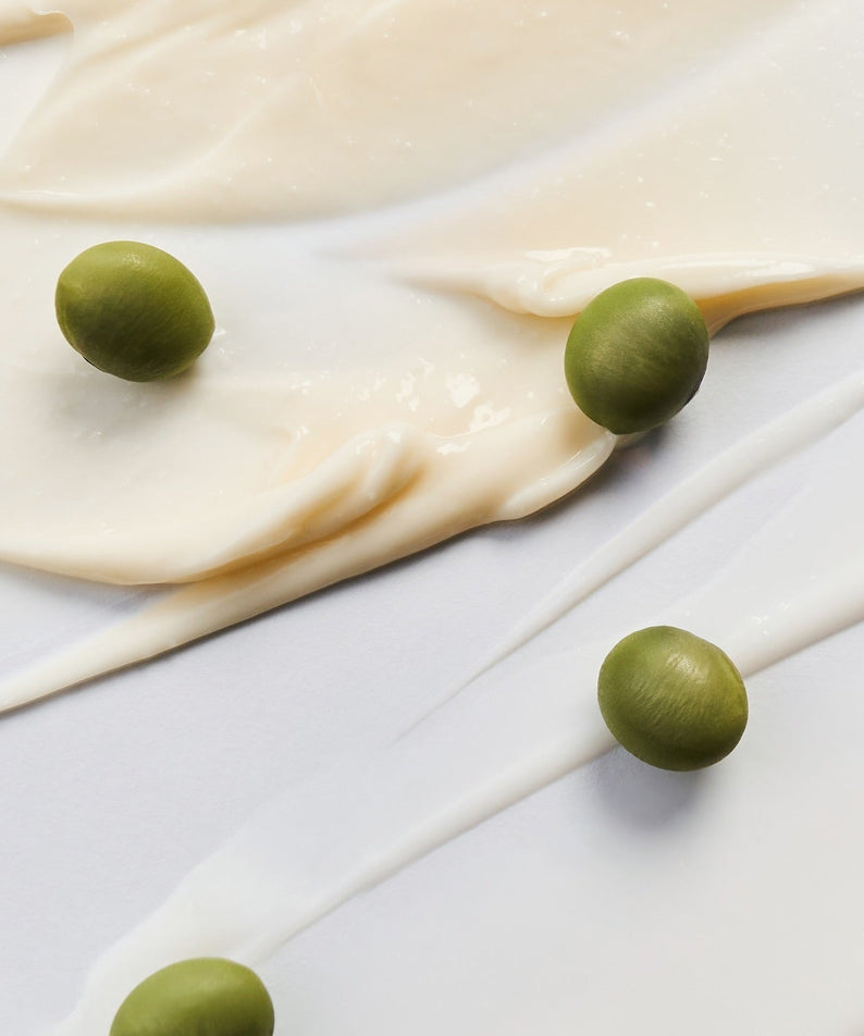 Smooth texture of BRINGGREEN Blue Bean B5-PDRN Mild Lotion 230ml with green beans on white background