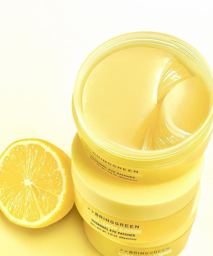 BRINGGREEN Super Lemon Glutathione Hydrogel Eye Patch 60 Sheets with fresh lemon on a bright yellow background