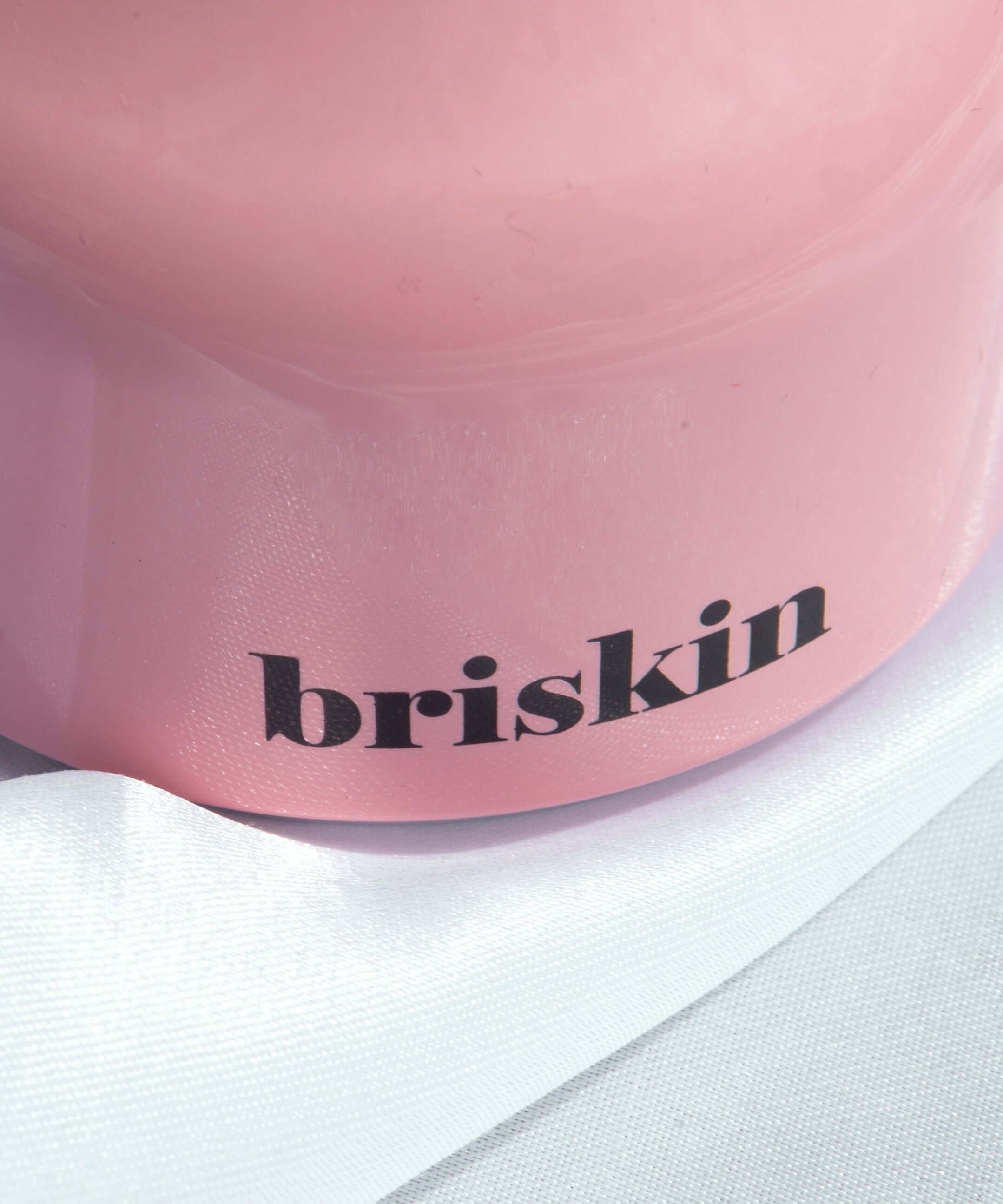 BRISKIN Face & Body Calming Ice Therapy in pink container with elegant design, showcasing the brand name "briskin" prominently.