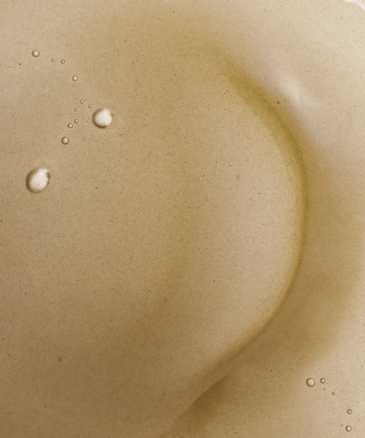 Close-up of BRMUD Deep melting Mud Pore Cleansing Oil 200ML texture with bubbles