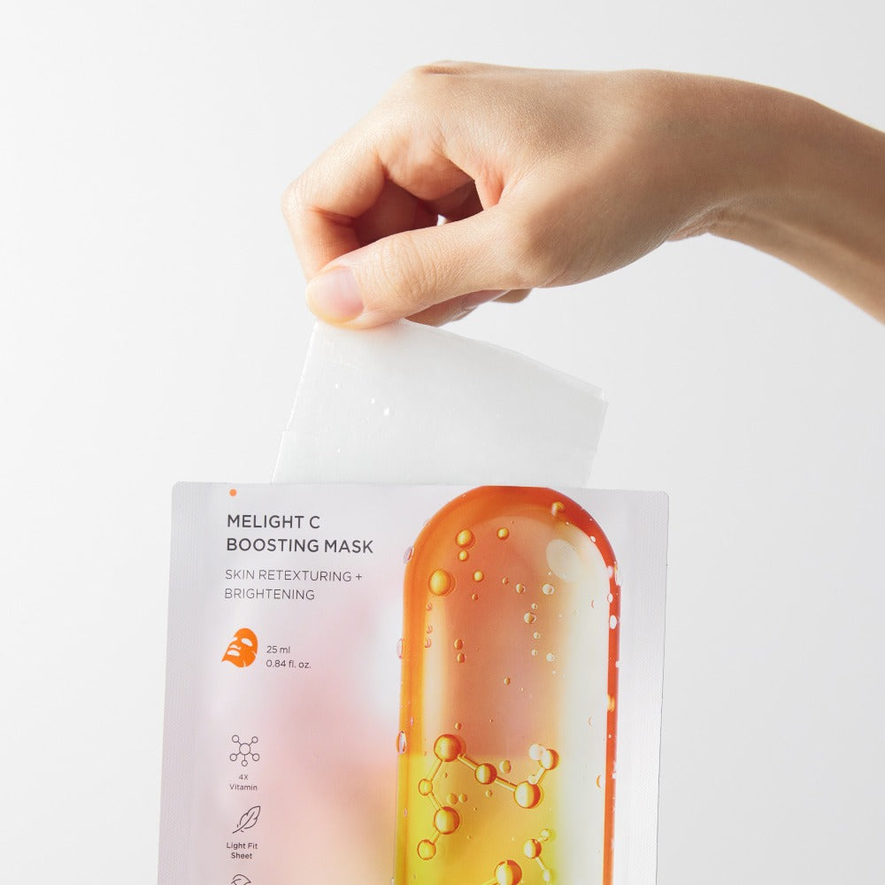BRTC Melight C Boosting Mask 10 Sheets packaging displayed in hand for skin brightening and retexturing.