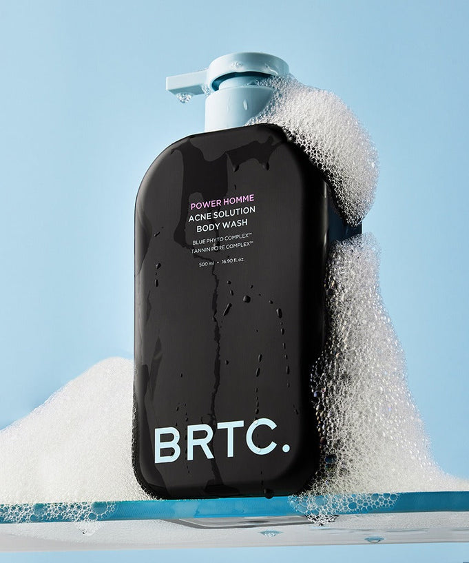 BRTC Power Homme Acne Solution Body Wash 500ml bottle with bubbles on a blue background.