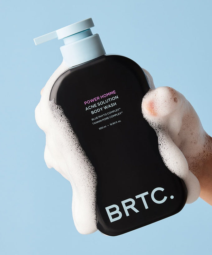 BRTC Power Homme Acne Solution Body Wash 500ml in a soapy hand against a light background.